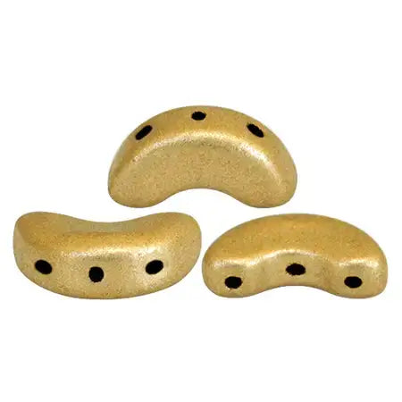 Three light gold curved beads with multiple black holes on a white background