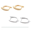 Two pairs of rectangular hoop earrings with embedded clear stones, one gold and one silver