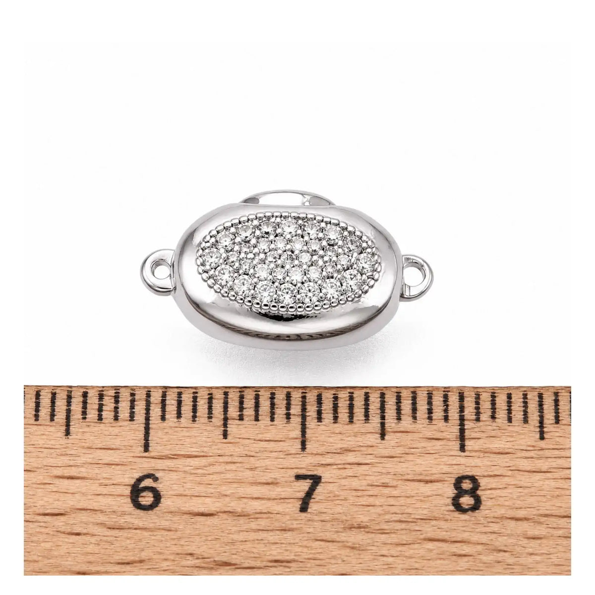 Platinum Luna bayonet peanut clasp shown beside a ruler for size reference