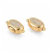 Gold Luna bayonet peanut clasp with clear cubic zirconia shown from an angled detail view
