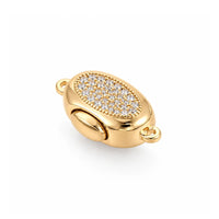 Gold Luna bayonet peanut clasp with clear cubic zirconia on a white background