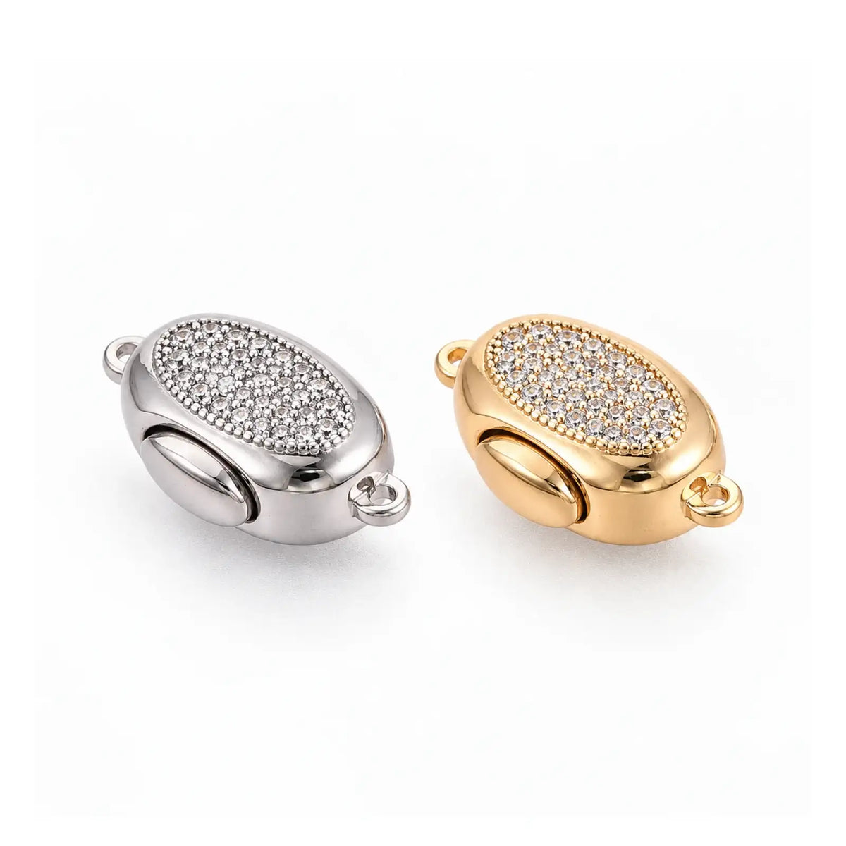 Gold and platinum Luna bayonet peanut clasps with clear cubic zirconia on a white background