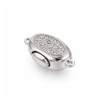 Platinum Luna bayonet peanut clasp with clear cubic zirconia on a white background