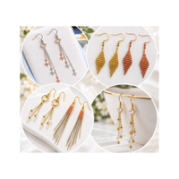 Examples of handmade dangling earrings featuring fishhook ear wires with beaded designs, decorative charms, delicate chains and crystal accents.