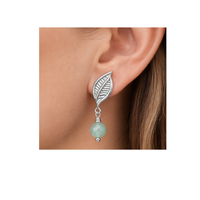 Monaco 7 silver-tone leaf-shaped earring stud worn on an ear with a mint green bead dangle attached through the bottom loop