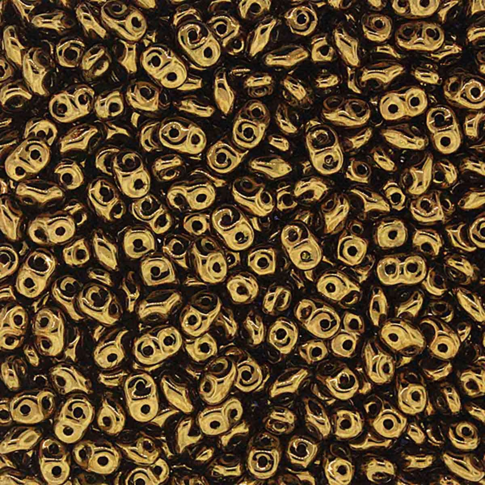 Close-up of superduo 2-hole gold beads with a metallic sheen.