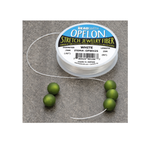 Opelon stretch jewelry fiber cord shown with green beads for stretch bracelet making