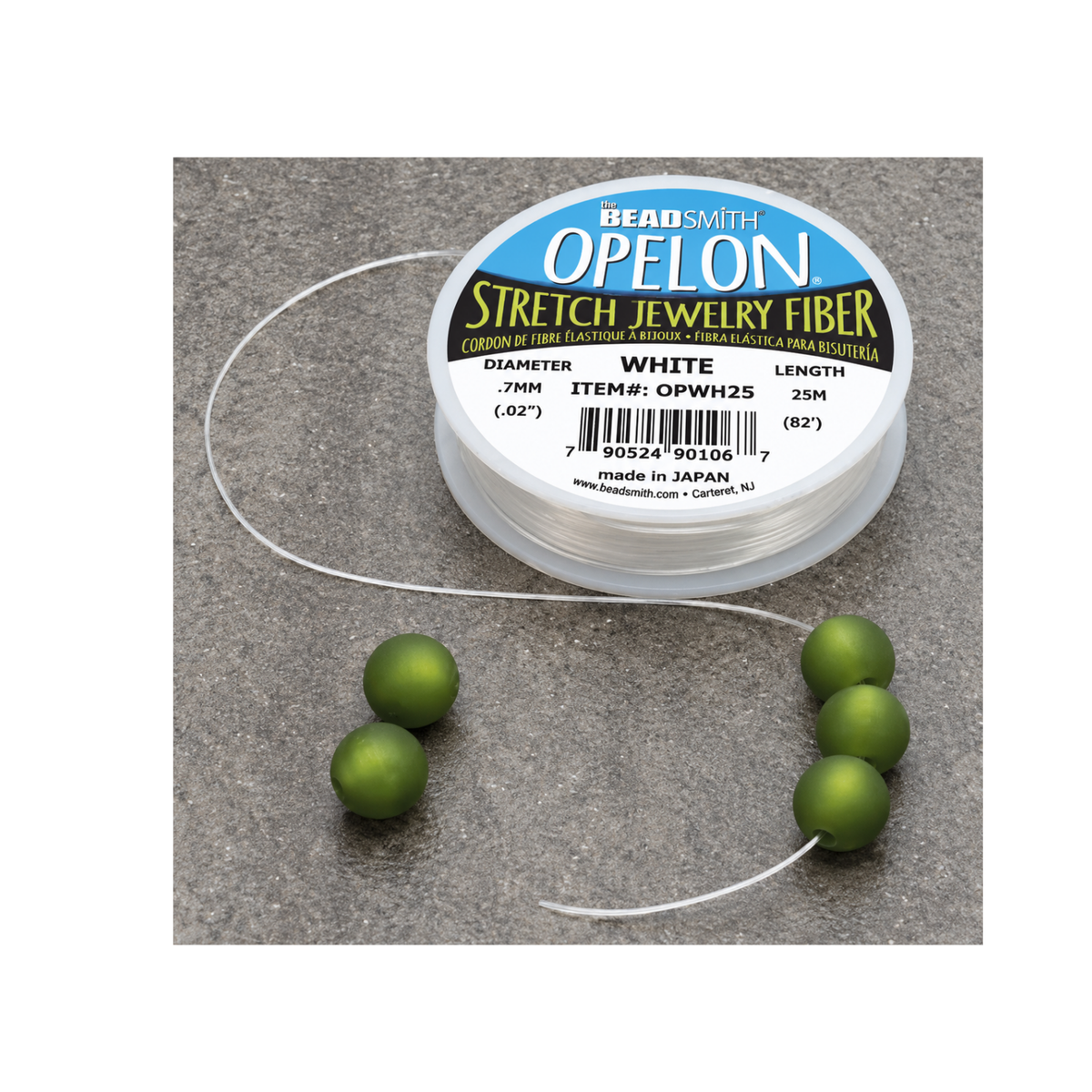 Opelon stretch jewelry fiber cord shown with green beads for stretch bracelet making