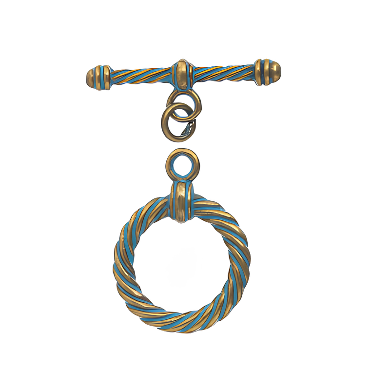 Decorative metal toggle with a patina and gold twisted design on a white background