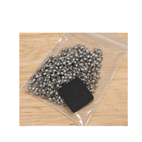 Shine-Rite anti-tarnish tab stored with metal jewelry findings in a resealable bag.