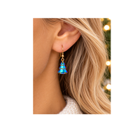Delicate gold earring featuring a blue Swarovski crystal Christmas tree charm attached through its top hole