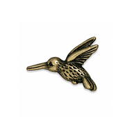 TierraCast 20mm hummingbird bead in Antique Brass on a white background.