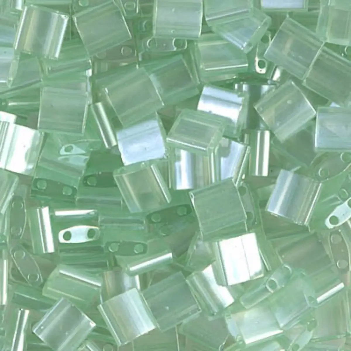 Close-up of green glass 2-hole beads called tila beads