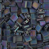 Close-up of iridescent square 2-holbeads with metallic sheen. 