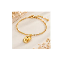 Gold cowboy hat charm used on a delicate bracelet for western jewelry design inspiration