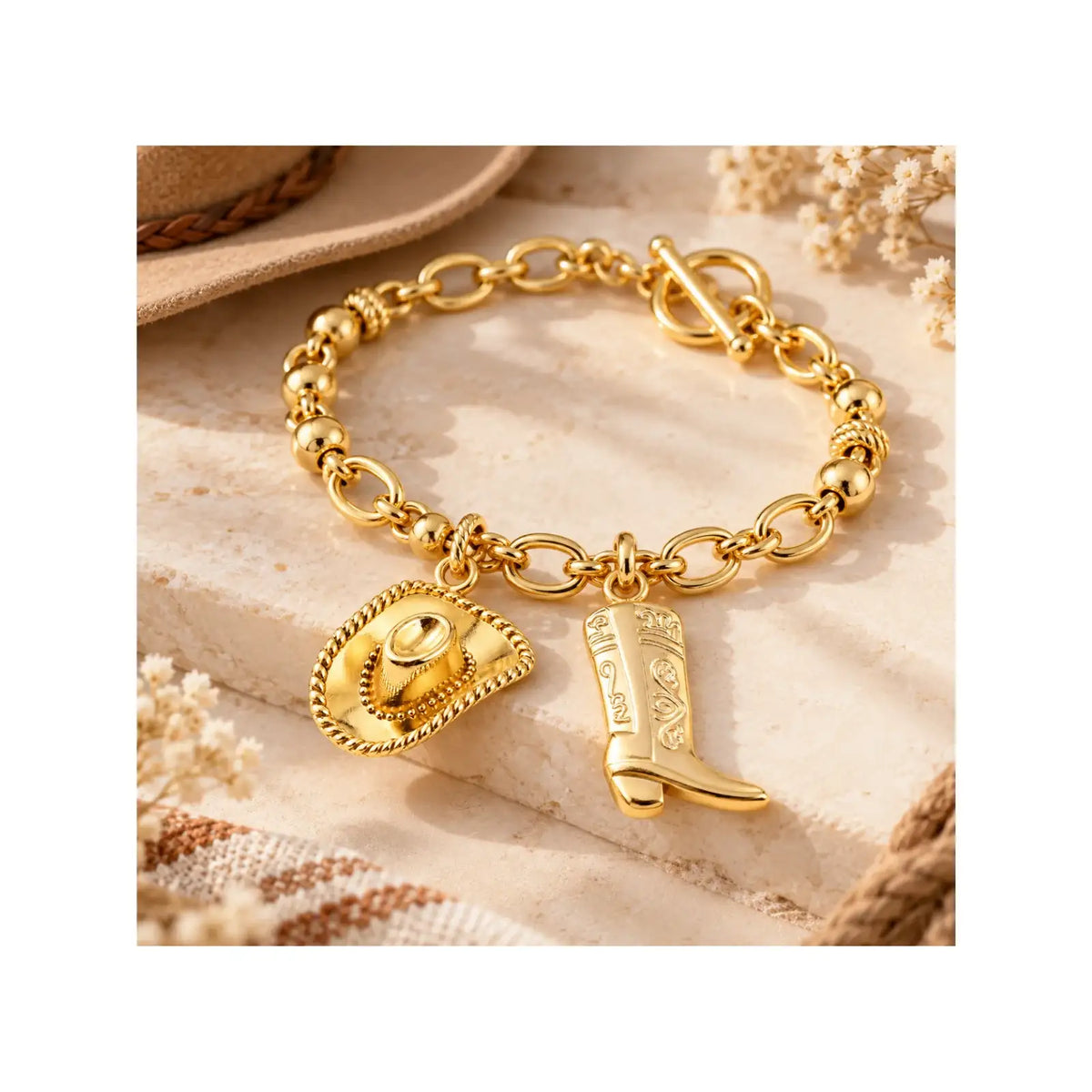 Gold cowboy boot and cowboy hat charms used on a western-inspired bracelet for design inspiration