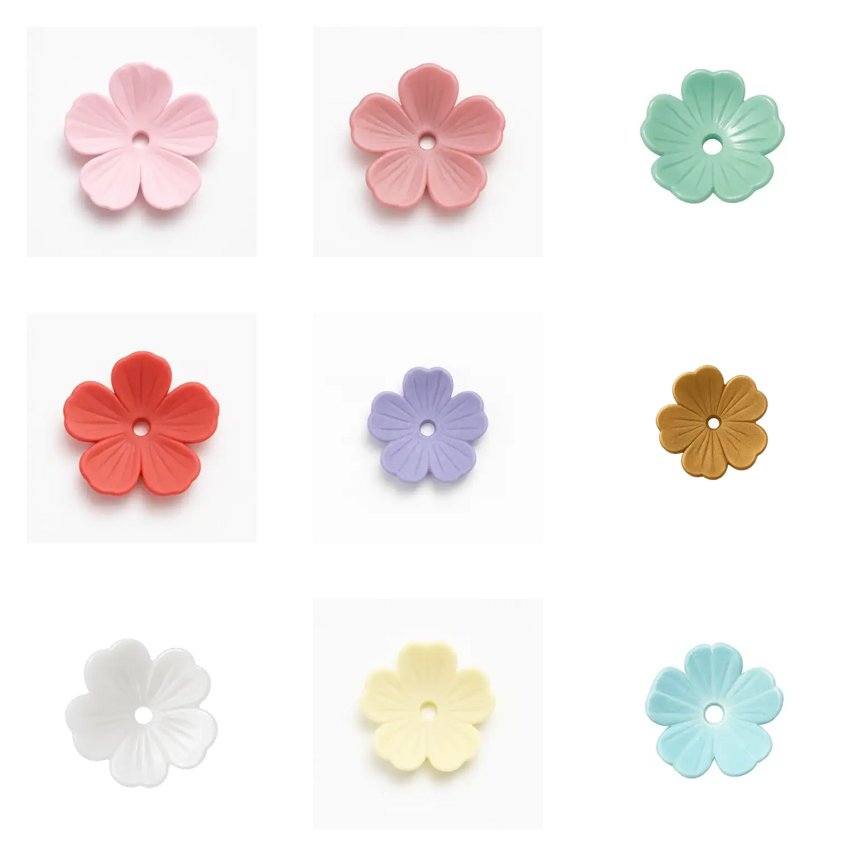 Set of nine colorful flower-shaped beads with central holes on white background
