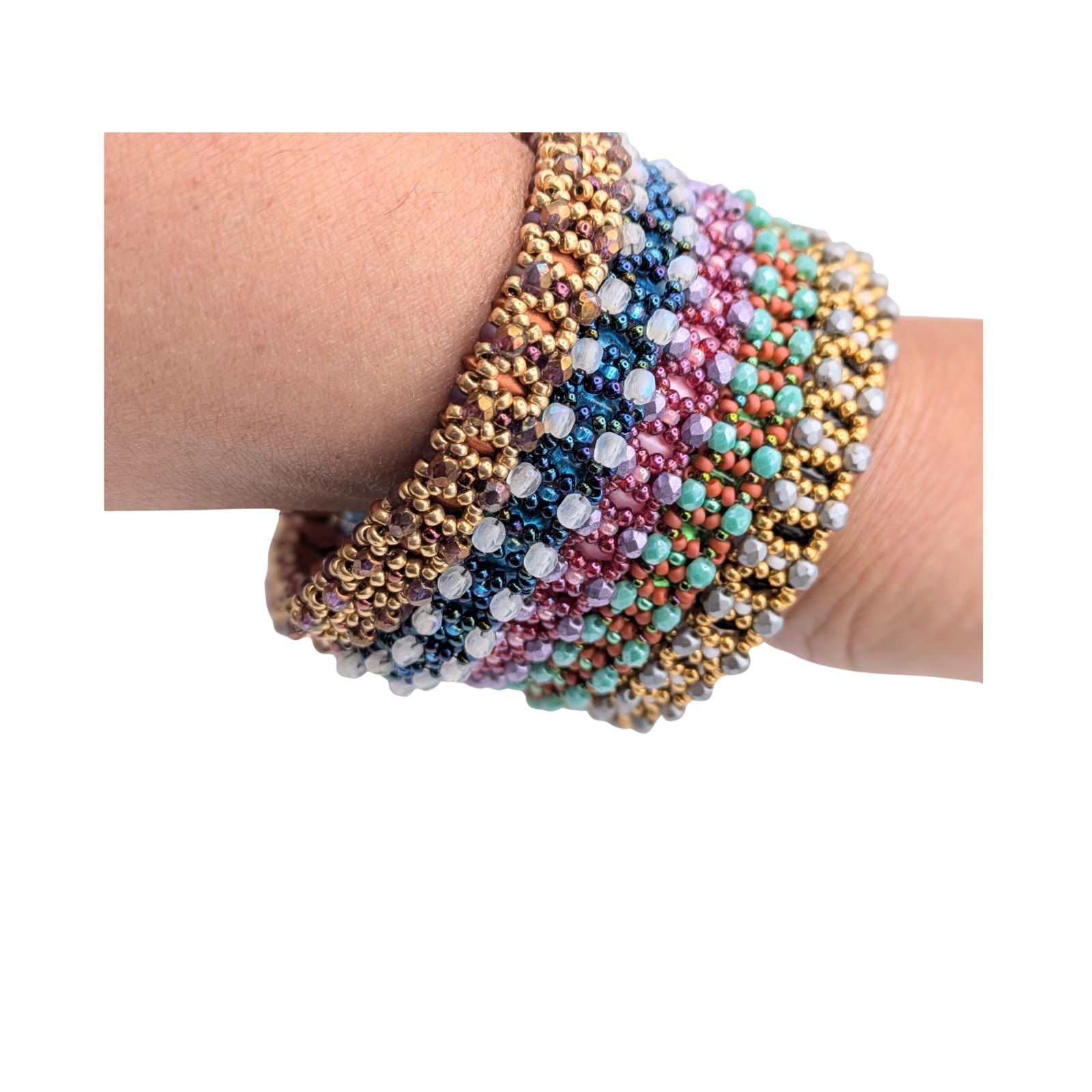 Multicolored beaded bracelets on a wrist against a white background